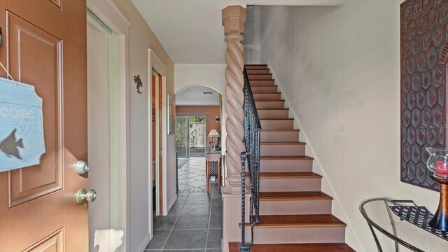 staircase featuring tile patterned flooring