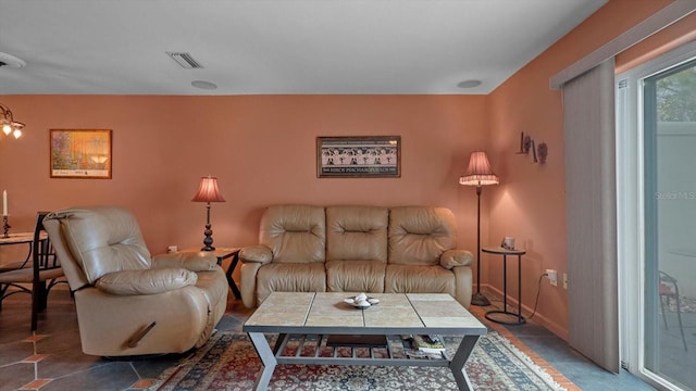 living area with baseboards and visible vents