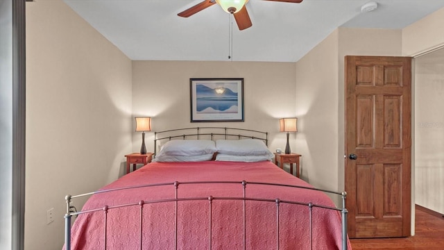 bedroom with a ceiling fan and wood finished floors