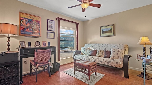 office featuring a ceiling fan, baseboards, and wood finished floors