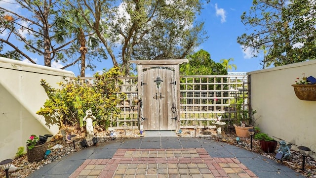 view of gate with fence