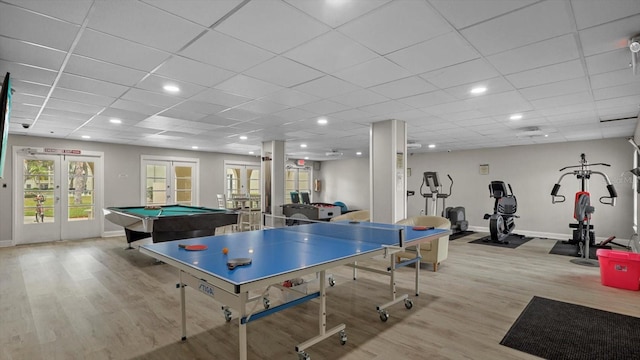 recreation room with a paneled ceiling, french doors, pool table, and light hardwood / wood-style flooring