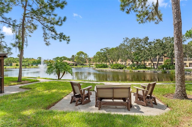 view of property's community featuring a yard and a water view