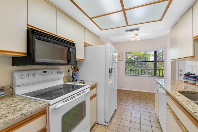 kitchen with white appliances, visible vents, baseboards, and light tile patterned floors