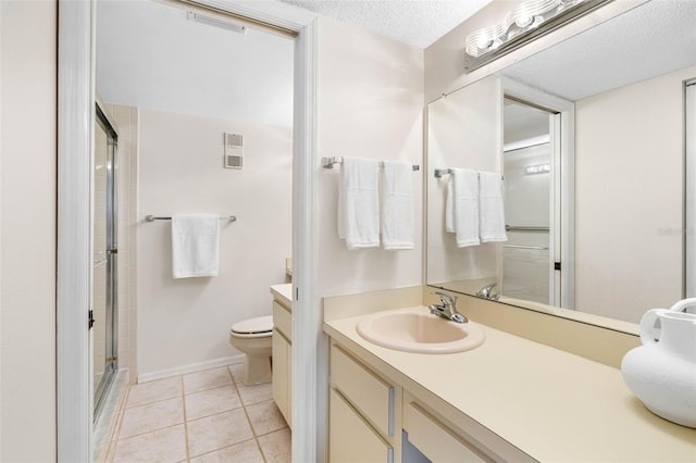 bathroom featuring toilet, tile patterned flooring, a textured ceiling, vanity, and a shower stall