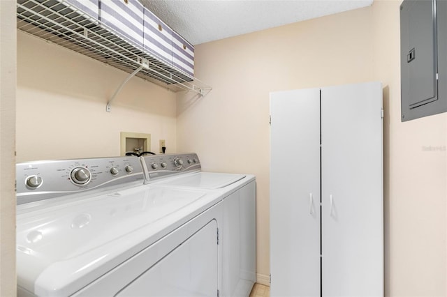 clothes washing area with laundry area, electric panel, and separate washer and dryer