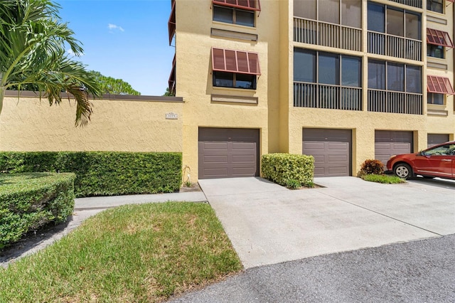 view of property featuring a garage and driveway