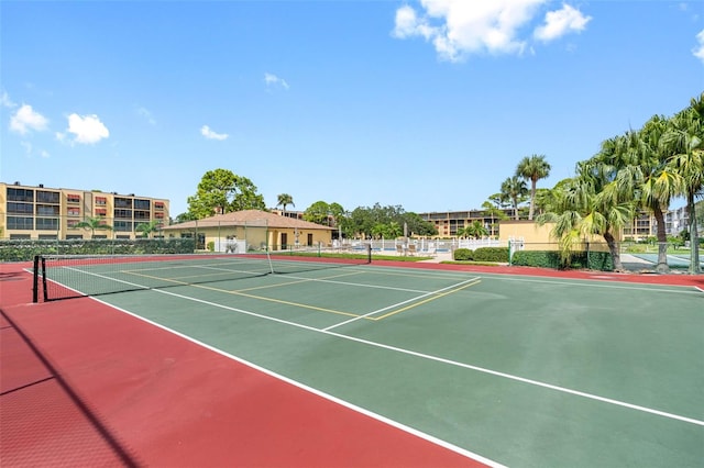 view of tennis court featuring community basketball court and fence