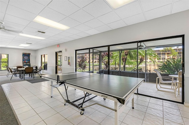 rec room with a paneled ceiling, tile patterned flooring, and visible vents