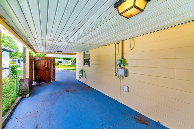 view of patio / terrace featuring a carport and fence