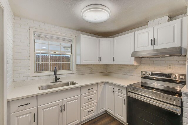 kitchen with stainless steel range with electric stovetop, white cabinets, light countertops, and under cabinet range hood