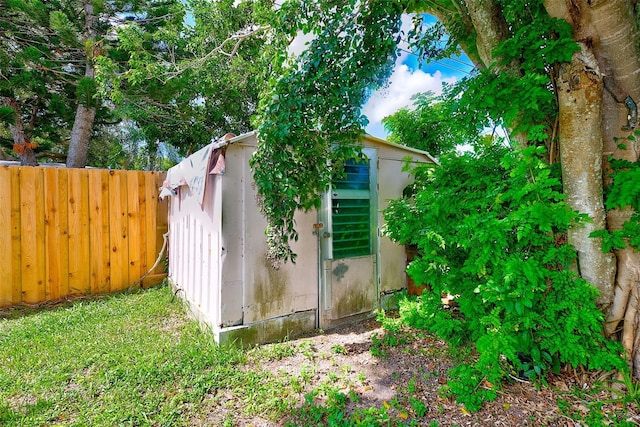 view of shed featuring fence