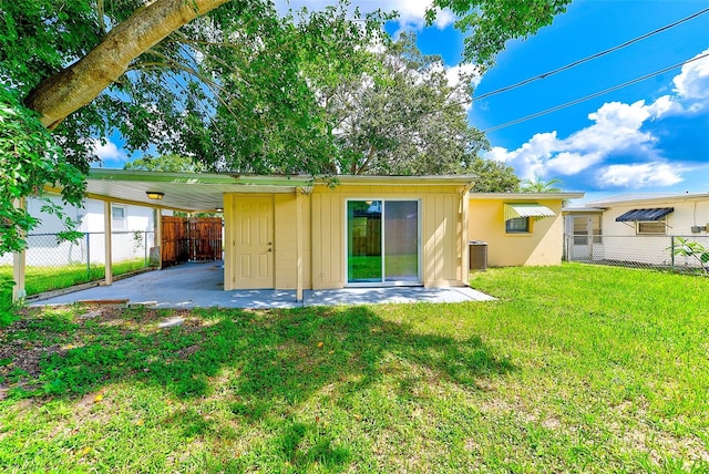 back of property with a yard, central AC unit, a patio, and fence