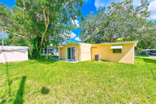 rear view of house with a lawn