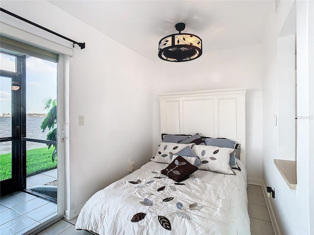 bedroom featuring access to exterior and light tile patterned floors