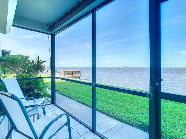 sunroom / solarium with a water view