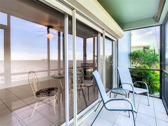 sunroom / solarium featuring a water view