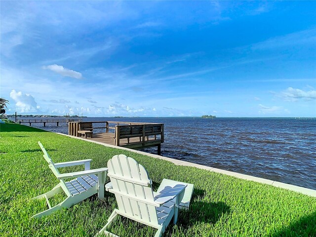 dock area featuring a yard and a water view