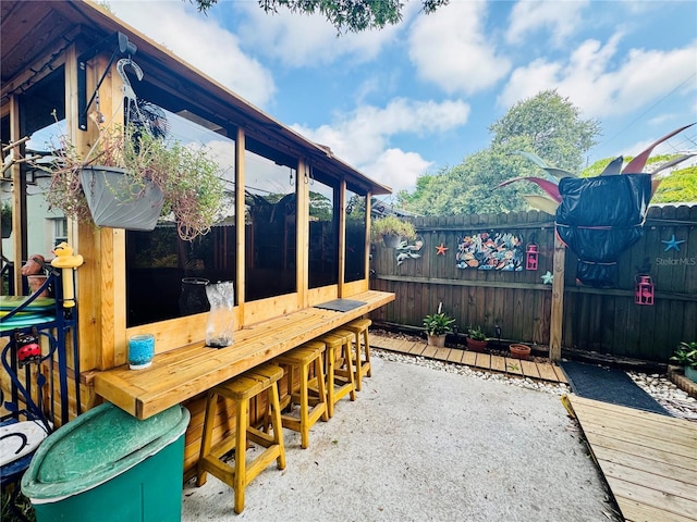 view of patio / terrace with fence and outdoor dry bar