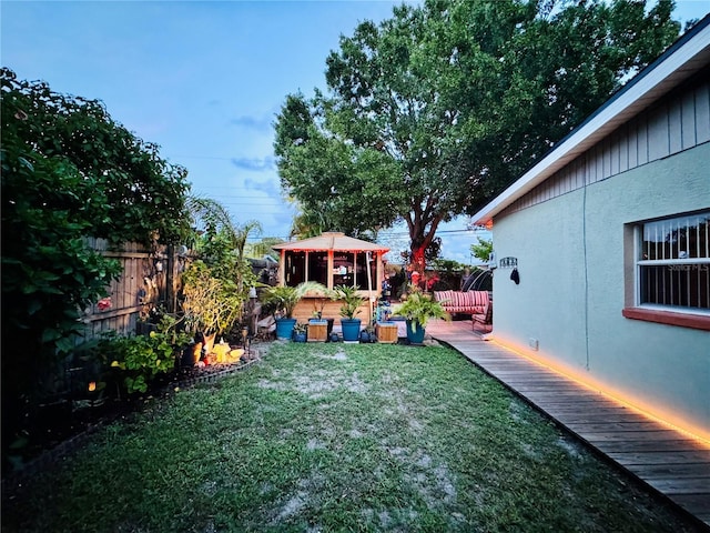 view of yard with a gazebo, a deck, and fence