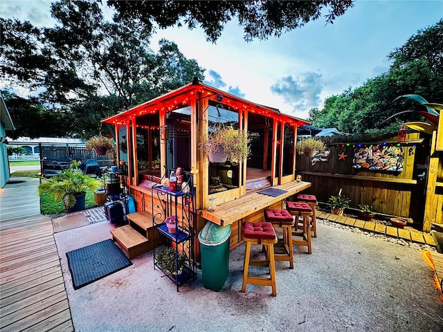 exterior space featuring outdoor dry bar and fence