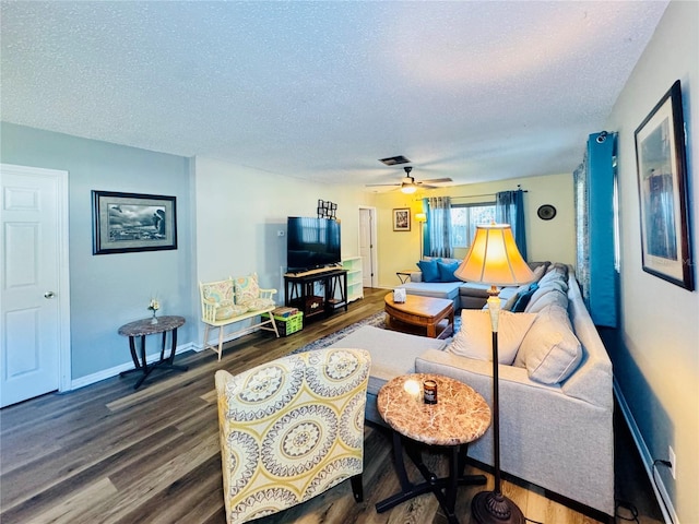 living room with ceiling fan, hardwood / wood-style flooring, and a textured ceiling