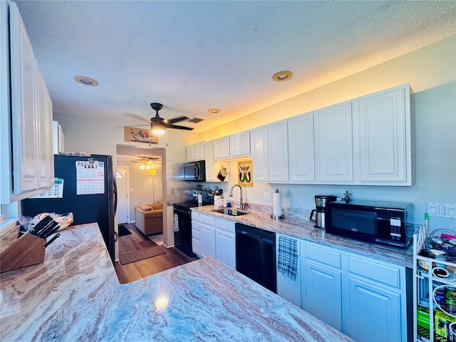 kitchen with black appliances, white cabinets, a ceiling fan, and a sink