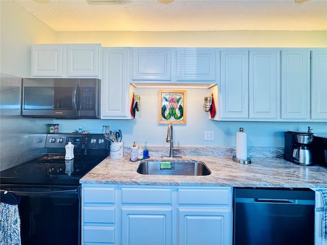 kitchen with white cabinetry, light stone countertops, sink, a textured ceiling, and black appliances