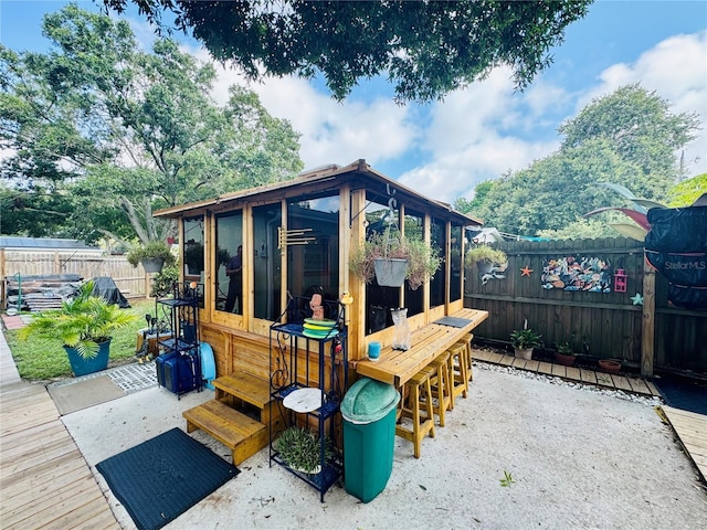 exterior space with outdoor dry bar and a fenced backyard