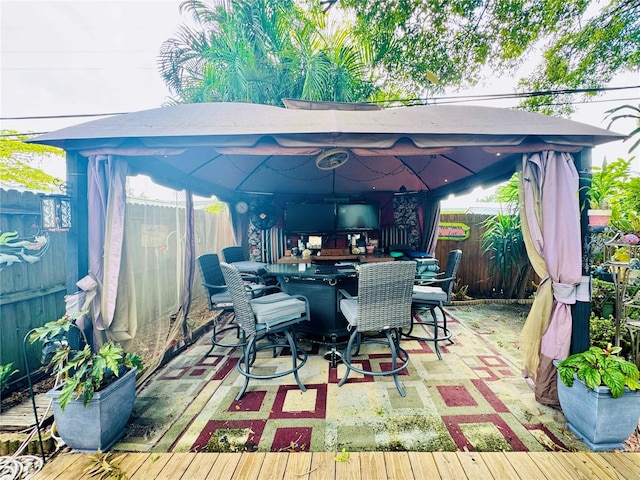 view of patio featuring a gazebo, outdoor dry bar, and a fenced backyard