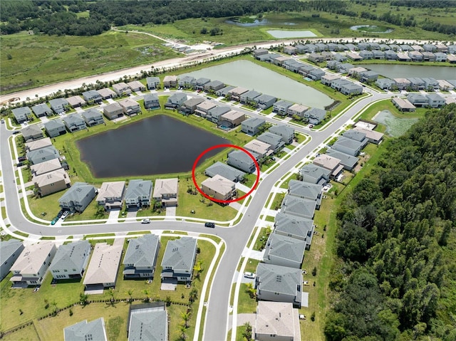 birds eye view of property with a water view