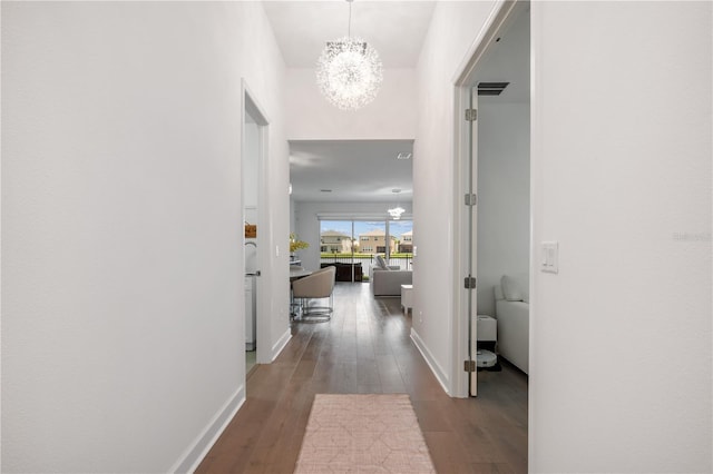 hall with a chandelier and hardwood / wood-style flooring