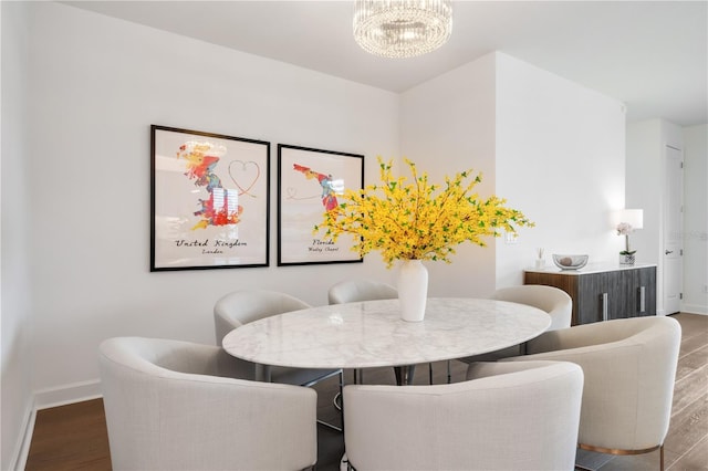 dining area with a notable chandelier and hardwood / wood-style flooring