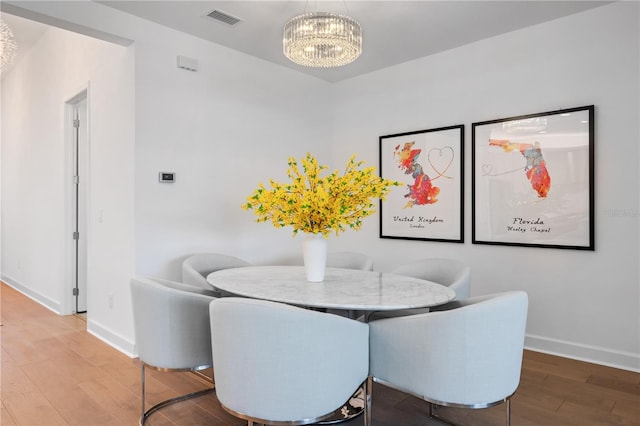 dining room with an inviting chandelier and hardwood / wood-style floors