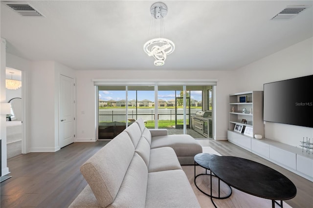 living room featuring an inviting chandelier and hardwood / wood-style floors