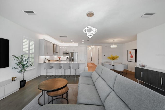 living room featuring dark hardwood / wood-style flooring and a notable chandelier