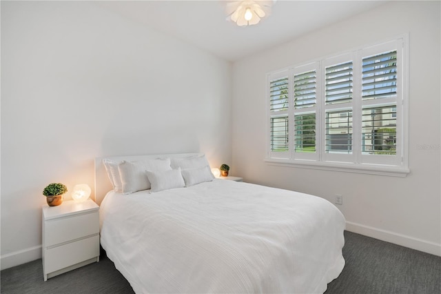 bedroom featuring dark colored carpet