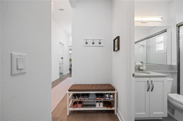 bathroom with toilet, wood-type flooring, vanity, and walk in shower