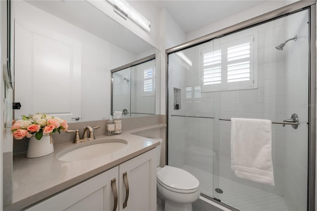 bathroom with vanity, toilet, and walk in shower