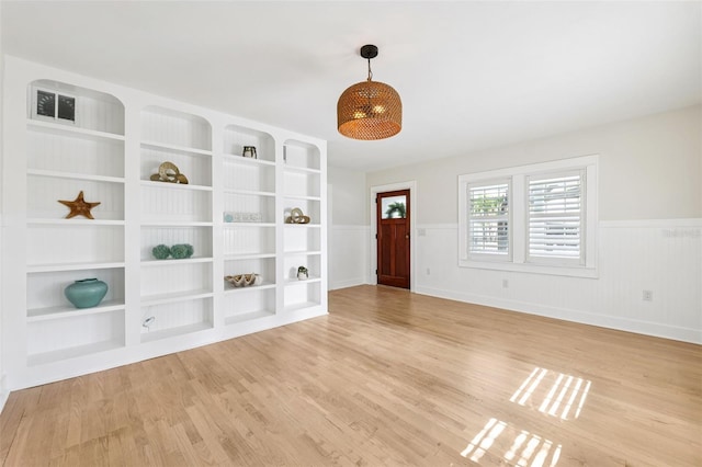 106 19th Ave, St Pete Beach, FL 33706 - entrance foyer featuring light wood-style floors and wainscoting