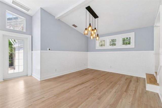 106 19th Ave, St Pete Beach, FL 33706 - empty room with light wood-type flooring, wainscoting, plenty of natural light, and a chandelier
