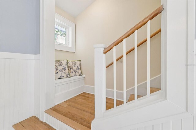106 19th Ave, St Pete Beach, FL 33706 - stairs featuring a wainscoted wall and wood finished floors