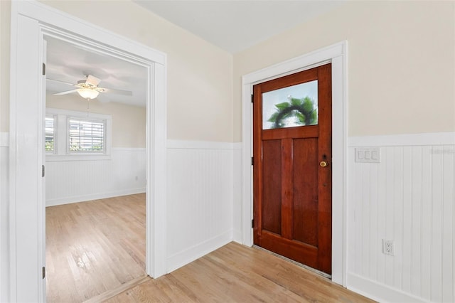 106 19th Ave, St Pete Beach, FL 33706 - entryway with wainscoting, light wood-style floors, and ceiling fan