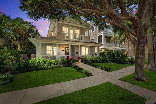 106 19th Ave, St Pete Beach, FL 33706 - view of front facade featuring a porch and a front lawn