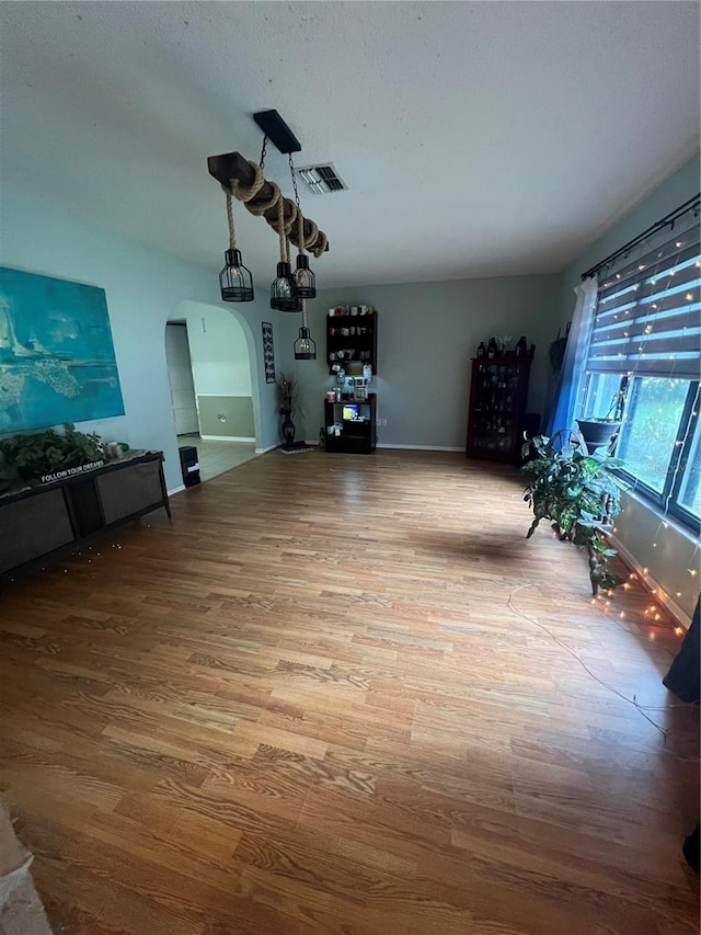 unfurnished living room featuring wood-type flooring