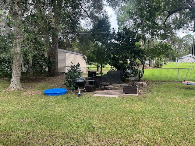 view of yard with an outdoor fire pit