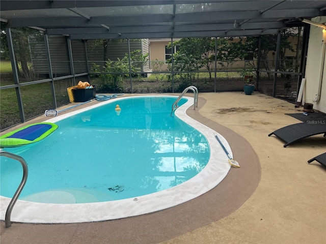 view of pool with a patio and a lanai