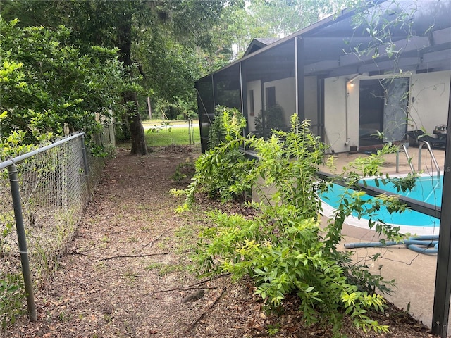 view of yard featuring a covered pool, a lanai, and a patio area