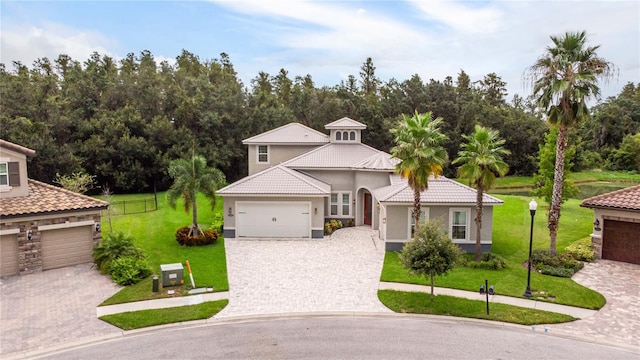 view of front of home with a garage and a front lawn