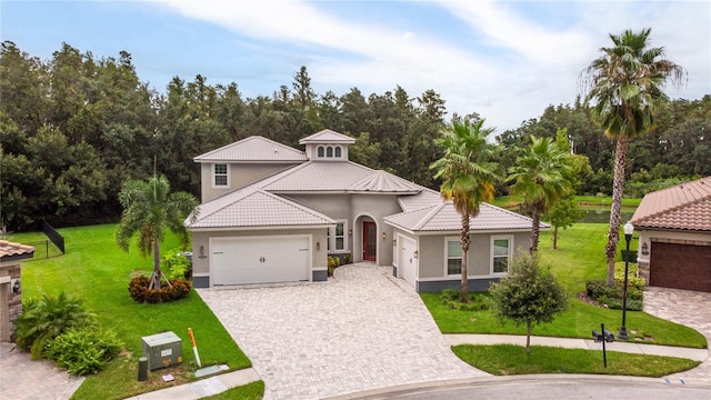 view of front of home with a garage and a front lawn